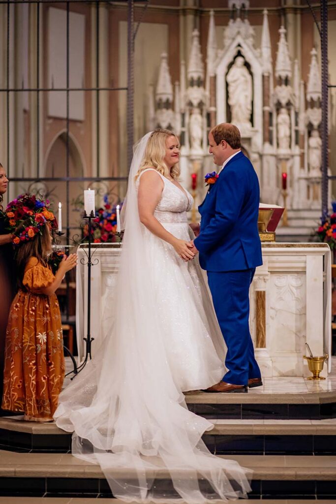 Bride and groom at the altar during their wedding ceremony at St Johns Church on Creighton University campus in Omaha Nebraska