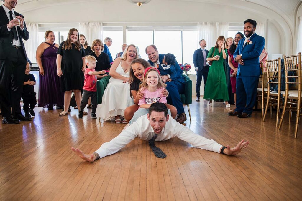 Wedding guests celebrating with bride and groom on the dance floor at the Cottonwood Hotel in Omaha Nebraska