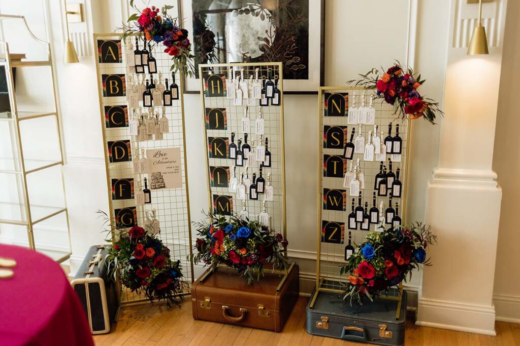 Travel themed wedding seating chart with luggage tags and vintage suitcases at the Cottonwood Hotel in Omaha Nebraska