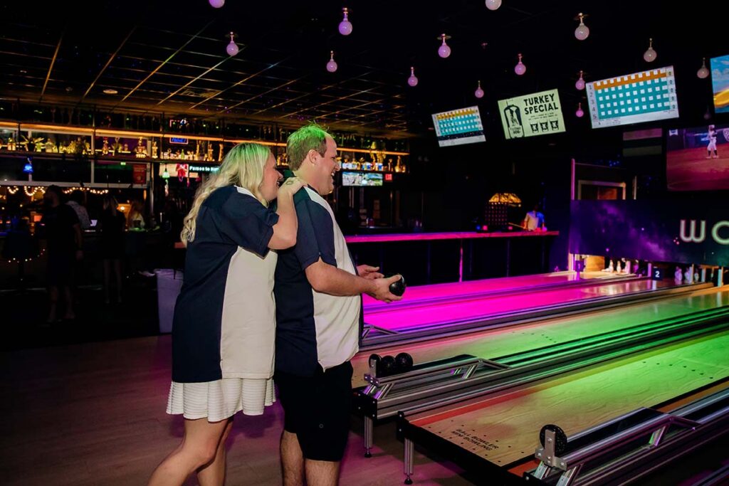 Bride and groom laughing together at Wonderbowl wedding after party in Omaha Nebraska