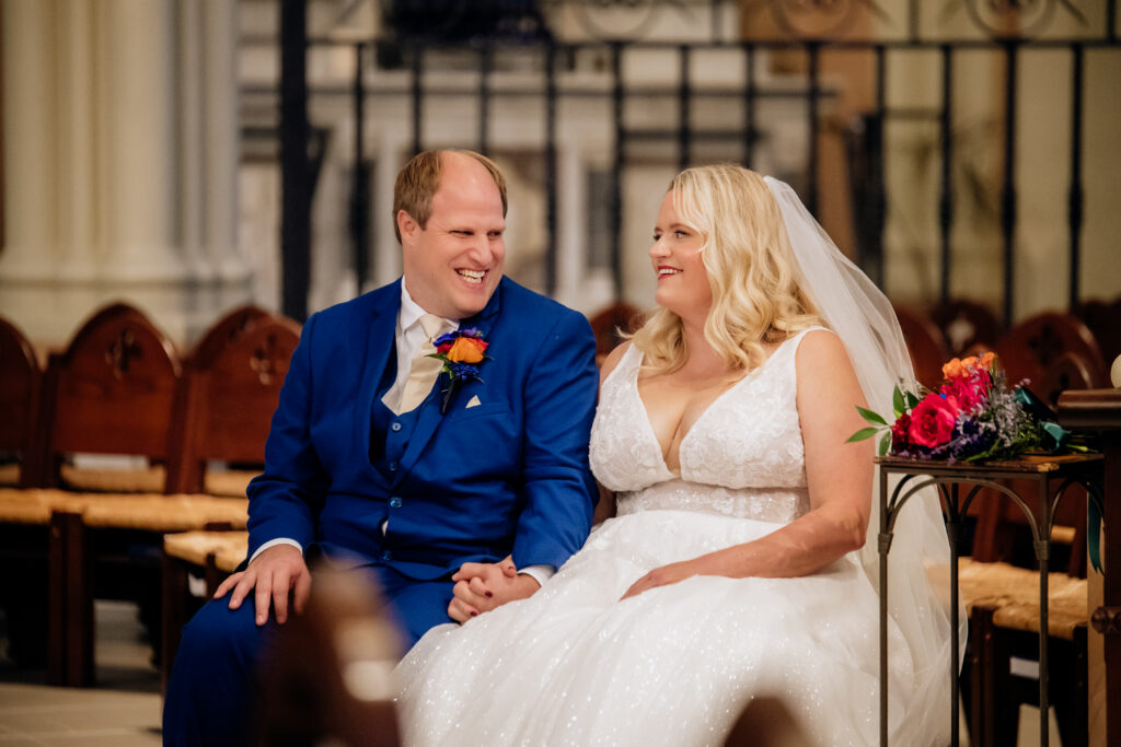 Bride and groom sharing a laugh during their wedding ceremony at St Johns Church in Omaha Nebraska
